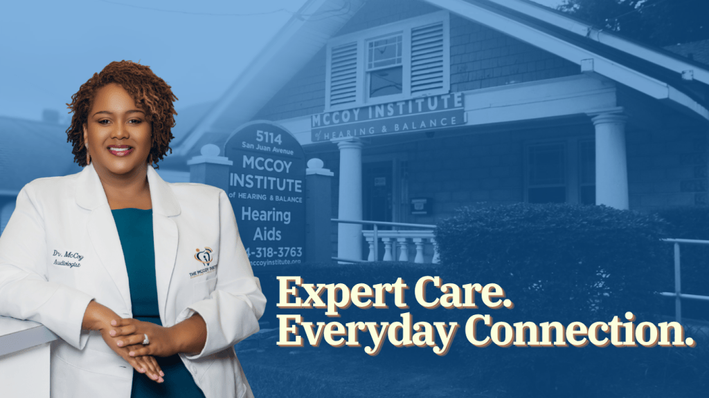 A professional woman in a lab coat, standing in front of the McCoy Institute for Hearing & Balance, with a welcoming smile and the tagline 'Expert Care. Everyday Connection.' displayed.